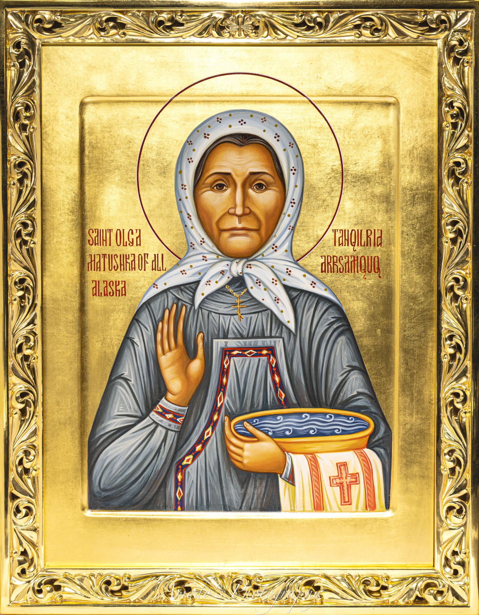 Orthodox Christian icon of Saint Olga, Matriarch of All Alaska, depicted with a halo, holding a bowl of water and a cloth with a cross, framed in gold.